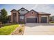 Lovely two-story brick home features a well-manicured lawn and mature trees creating a picturesque setting at 7472 Iridium Way, Castle Rock, CO 80108