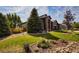 Charming front exterior of home boasts a well-manicured lawn and garden beds, showcasing curb appeal at 7472 Iridium Way, Castle Rock, CO 80108