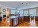 Open kitchen with a granite island, stainless steel dishwasher, and hardwood floors at 7472 Iridium Way, Castle Rock, CO 80108