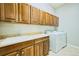 Laundry room with plenty of cabinet storage, a sink and countertop, and a washing machine and dryer at 7472 Iridium Way, Castle Rock, CO 80108