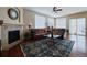 Living room featuring a fireplace, hardwood floors, and a large sectional sofa at 7472 Iridium Way, Castle Rock, CO 80108