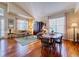 Bright living room with high ceilings, hardwood floors, and large windows at 7472 Iridium Way, Castle Rock, CO 80108