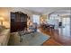 Cozy living room featuring hardwood floors and an antique hutch at 7472 Iridium Way, Castle Rock, CO 80108