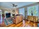 Bright living room featuring hardwood floors and a fireplace at 7472 Iridium Way, Castle Rock, CO 80108