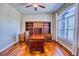 Office with hardwood floors, built-in shelving, and a large window at 7472 Iridium Way, Castle Rock, CO 80108