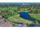 Aerial view of a lush golf course featuring well-manicured greens, ponds, and mature trees at 9316 E Harvard Ave, Denver, CO 80231