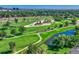 Aerial view of the beautiful golf course featuring lush green fairways, sand traps, and water features at 9316 E Harvard Ave, Denver, CO 80231