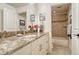 Well-appointed bathroom with granite vanity and tub with tiled surround at 9316 E Harvard Ave, Denver, CO 80231