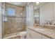 Modern bathroom with tiled walk-in shower, granite vanity, and stylish fixtures at 9316 E Harvard Ave, Denver, CO 80231