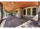 Expansive covered patio with stone columns and wood ceiling perfect for outdoor entertaining at 9316 E Harvard Ave, Denver, CO 80231