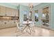 Charming dining area with a round table, modern chairs, decorative lighting, and beautiful natural light at 9316 E Harvard Ave, Denver, CO 80231