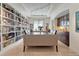 Elegant dining room with hardwood floors, custom bookshelves, and modern lighting at 9316 E Harvard Ave, Denver, CO 80231