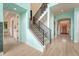 Welcoming foyer with modern staircase, beautiful trimwork, and hardwood floors at 9316 E Harvard Ave, Denver, CO 80231