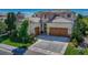 Stunning home exterior with a clay tile roof, three-car garage, and stone accents at 9316 E Harvard Ave, Denver, CO 80231