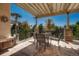 Outdoor patio with shaded pergola, perfect for dining, features modern furniture and garden views at 9316 E Harvard Ave, Denver, CO 80231