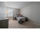 Well-lit bedroom with neutral walls, carpet, and a cozy nook with a side table at 6705 S Field St # 801, Littleton, CO 80128