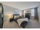 Comfortable bedroom with soft carpet, blackout curtains, and a decorative collection of pillows at 6705 S Field St # 801, Littleton, CO 80128