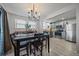 Dining area with chandelier, table with seating, adjacent to kitchen with stainless steel appliances at 6705 S Field St # 801, Littleton, CO 80128