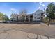 Multi-level condominium building with balconies, parking, and mature trees on a sunny day at 6705 S Field St # 801, Littleton, CO 80128