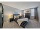 Comfortable main bedroom with neutral gray walls, plush carpet, and a large black dresser at 6705 S Field St # 801, Littleton, CO 80128