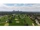 Breathtaking aerial view showcasing a lush golf course against the backdrop of the city skyline at 2626 N Steele St, Denver, CO 80205