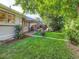 A lush backyard featuring a covered patio, manicured lawn, and mature landscaping at 2626 N Steele St, Denver, CO 80205