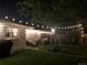Beautiful backyard with patio, string lights, and fire pit, perfect for outdoor entertaining at 2626 N Steele St, Denver, CO 80205