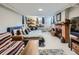 Finished basement features a cozy bed, desk space, brick fireplace, and neutral paint at 2626 N Steele St, Denver, CO 80205