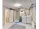 Basement laundry room with shower, washer, dryer, and a clean, organized layout at 2626 N Steele St, Denver, CO 80205