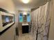 Cozy bathroom with decorative shower curtain and neutral-toned tile at 2626 N Steele St, Denver, CO 80205