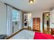 Bright bedroom with hardwood floors, a dresser, and a view to a bathroom and closet at 2626 N Steele St, Denver, CO 80205