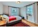 Cozy bedroom with hardwood floors, bright windows, and simple decor at 2626 N Steele St, Denver, CO 80205