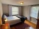 Comfortable bedroom featuring hardwood floors, large windows, and a cozy rug at 2626 N Steele St, Denver, CO 80205