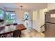 A cozy dining area with neutral tile flooring, a wood table, and natural light at 2626 N Steele St, Denver, CO 80205