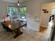 Bright dining area with large windows and a wooden table at 2626 N Steele St, Denver, CO 80205