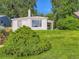 Attractive home with a brick facade, lush green lawn, and mature shade trees under a blue sky at 2626 N Steele St, Denver, CO 80205