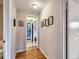 Bright hallway with hardwood floors, leading to a charming entryway and featuring lovely wall decor at 2626 N Steele St, Denver, CO 80205