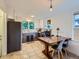 Bright kitchen with modern appliances, tile floors, and an adjacent dining area at 2626 N Steele St, Denver, CO 80205