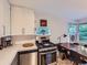 Updated kitchen featuring modern stainless steel appliances, white cabinetry, and tile flooring at 2626 N Steele St, Denver, CO 80205