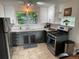 Updated kitchen featuring stainless steel appliances, light countertops, and ample cabinet space at 2626 N Steele St, Denver, CO 80205