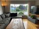 Bright living room with a large window, hardwood floors, and a comfortable sectional sofa at 2626 N Steele St, Denver, CO 80205