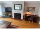 Living area featuring a fireplace, hardwood floors, and a cozy home office space at 2626 N Steele St, Denver, CO 80205