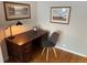 Cozy home office with a wooden desk, comfortable chair, and natural light at 2626 N Steele St, Denver, CO 80205
