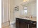 Clean bathroom featuring a vanity, toilet, shower with curtain, and decorative shelf at 3482 E 143Rd Dr, Thornton, CO 80602