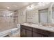 Well-lit bathroom featuring a double sink vanity, granite counters, and a tiled walk-in shower at 3482 E 143Rd Dr, Thornton, CO 80602