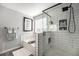 Modern bathroom showcasing white subway tile, a glass-enclosed shower, and a separate soaking tub at 5797 S Shawnee St, Aurora, CO 80015