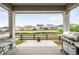 Back porch view of the backyard, fence, and other houses creates an inviting space at 14454 Grape Way, Brighton, CO 80602