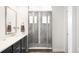 Bathroom featuring a new frameless glass shower, black cabinets and granite countertops at 14454 Grape Way, Brighton, CO 80602