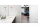 Half bathroom that leads into a gray bedroom at 14454 Grape Way, Brighton, CO 80602