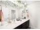 Modern bathroom with double sinks, a large mirror, and decorative accents at 14454 Grape Way, Brighton, CO 80602